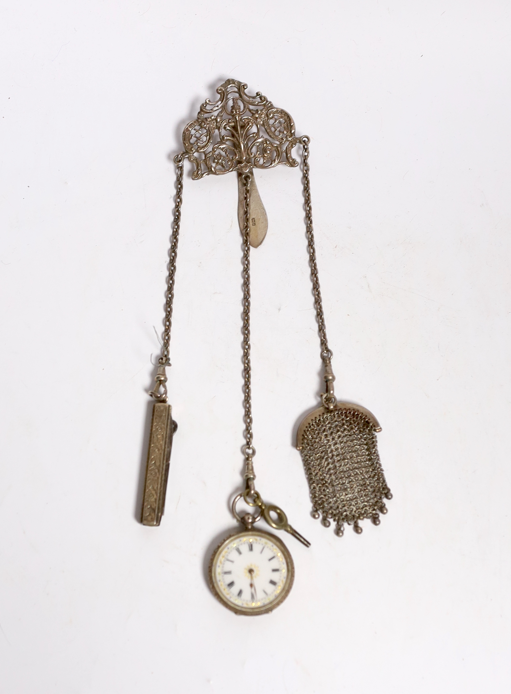 A late Victorian pierced silver chatelaine by Levi & Salaman, Birmingham, 1900, hung with three assorted accoutrements to include an unmarked mesh purse, pocket knife with button hook and a Swiss 935 fob watch, overall 2